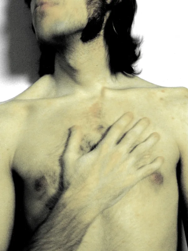 Faded-tone male torso with an open hand resting on the chest